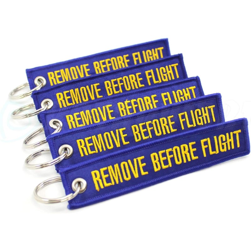 Υφασμάτινο μπρελόκ με Κέντημα REMOVE BEFORE FLIGHT μώβ Υφασμάτινο μπρελόκ με Κέντημα REMOVE BEFORE FLIGHT μώβ